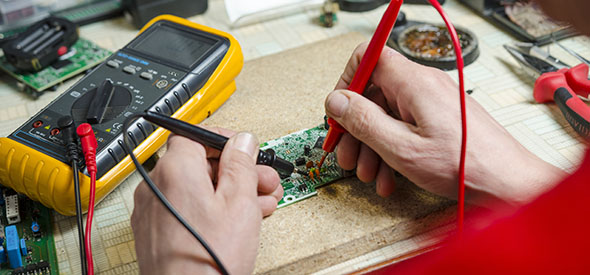man hands closeup repair electronic device using Multimetr. tools